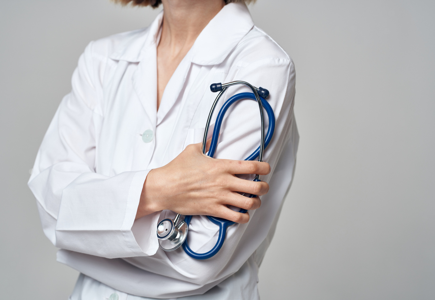 Woman in White Coat Doctor and Stethoscope in Hand