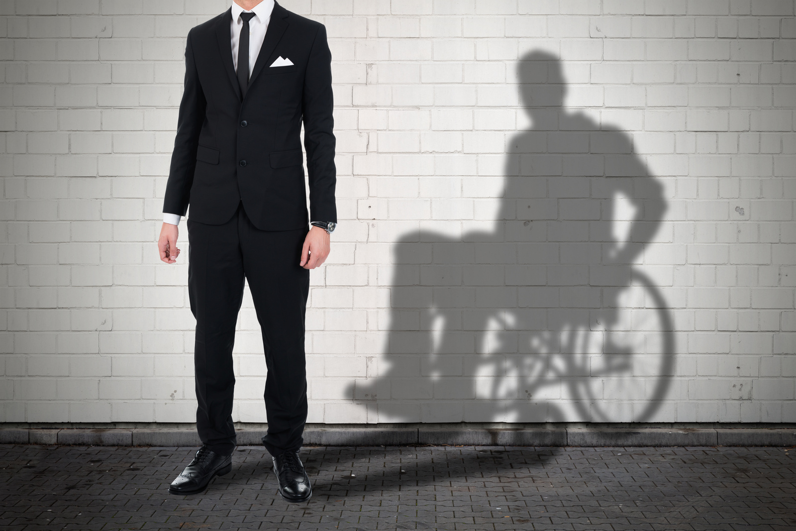Businessman Standing With Shadow Of A Disables Man